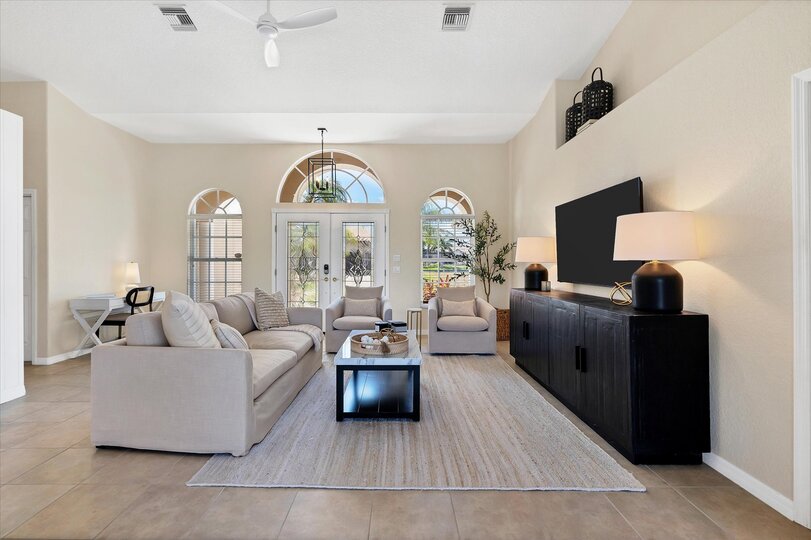 Bright, open living space with ample seating and 65-inch Smart TV