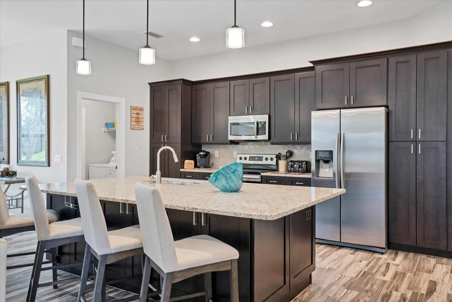 Gorgeous, fully-equipped kitchen featuring stainless steel appliances, and huge kitchen island that seats 4