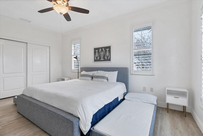 Guest bedroom has a king bed and two pullout twin trundle beds