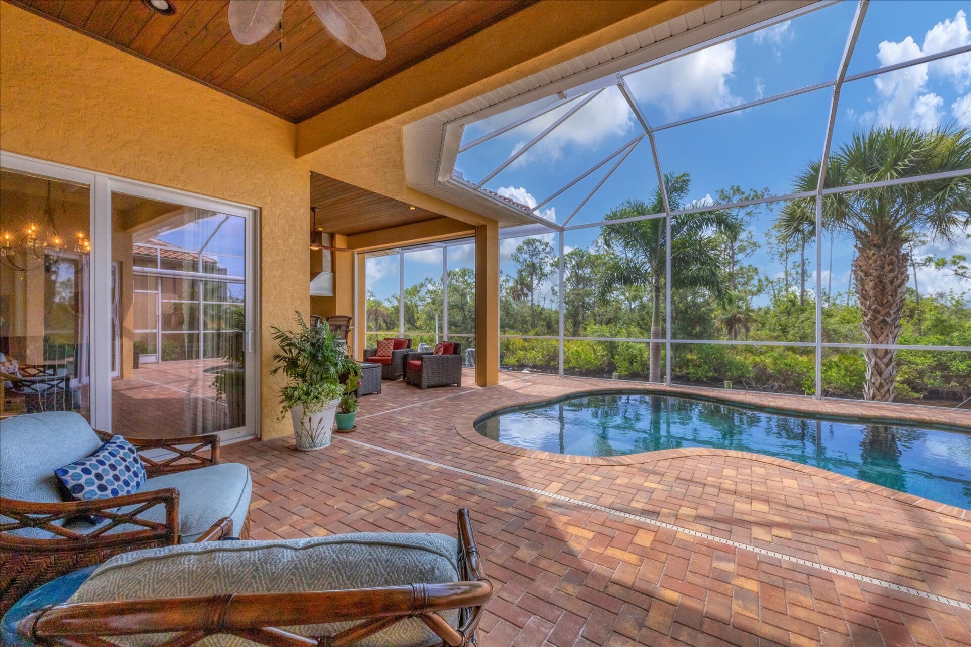 Large outdoor living space overlooking canal and nature preserve. Lanai features ample seating, outdoor kitchen, bar, 65-inch Smart TV, sparkling private pool & spa, and remote controlled privacy screens. Pool size is 17'L x 10'W x 6'D