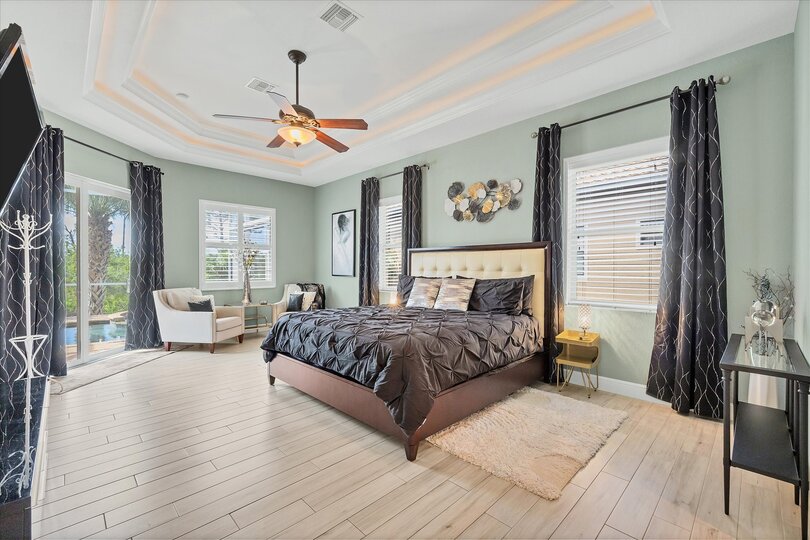 Large primary bedroom with king bed, en suite, lanai access, and  55-inch Roku TV
