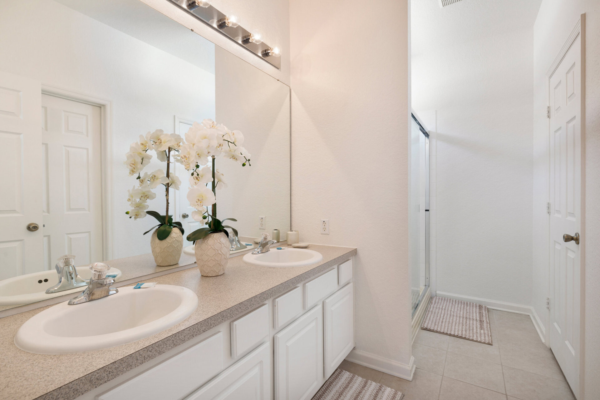 The ensuite bath has dual vanity and walk-in shower