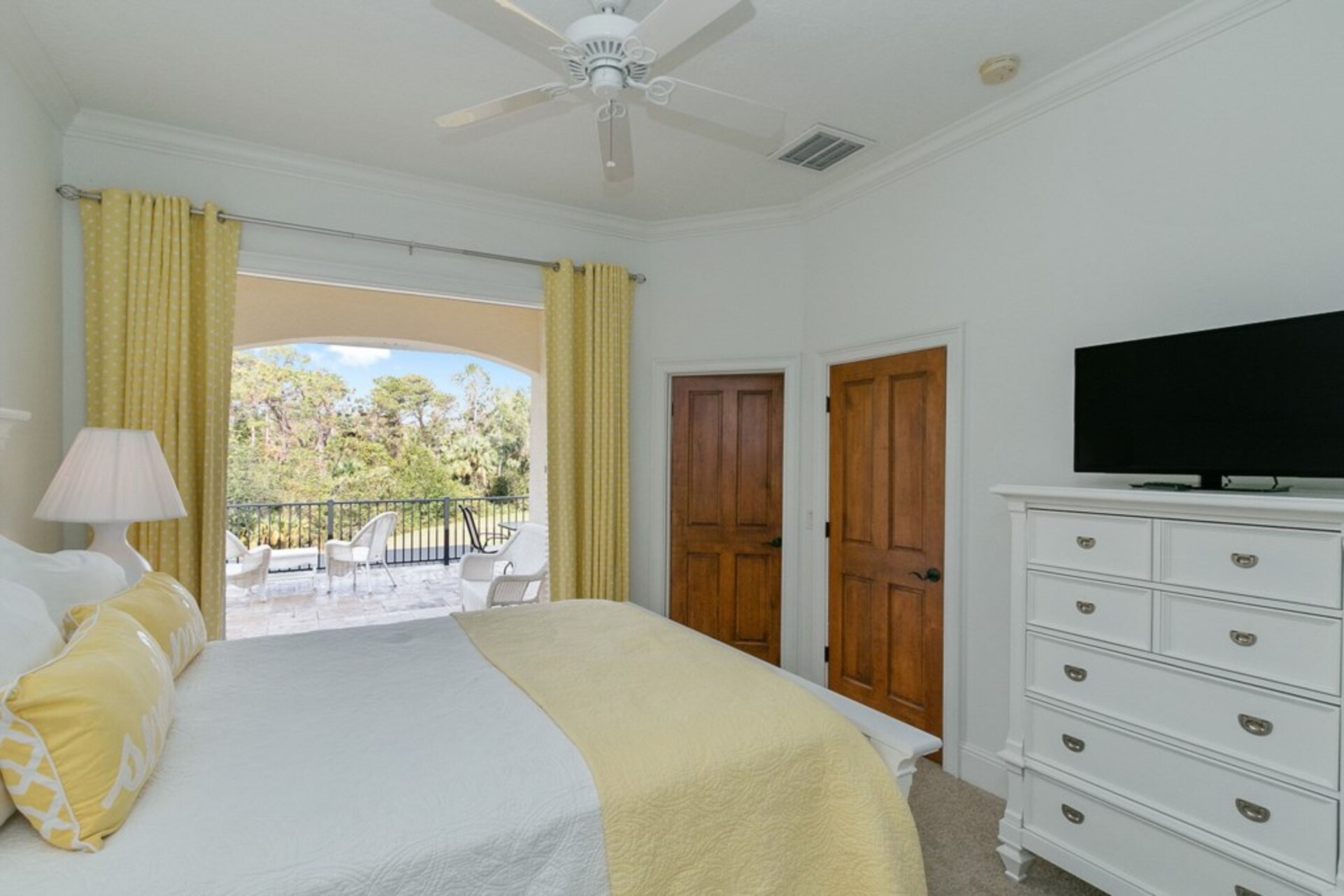 This gorgeous bedroom features balcony access