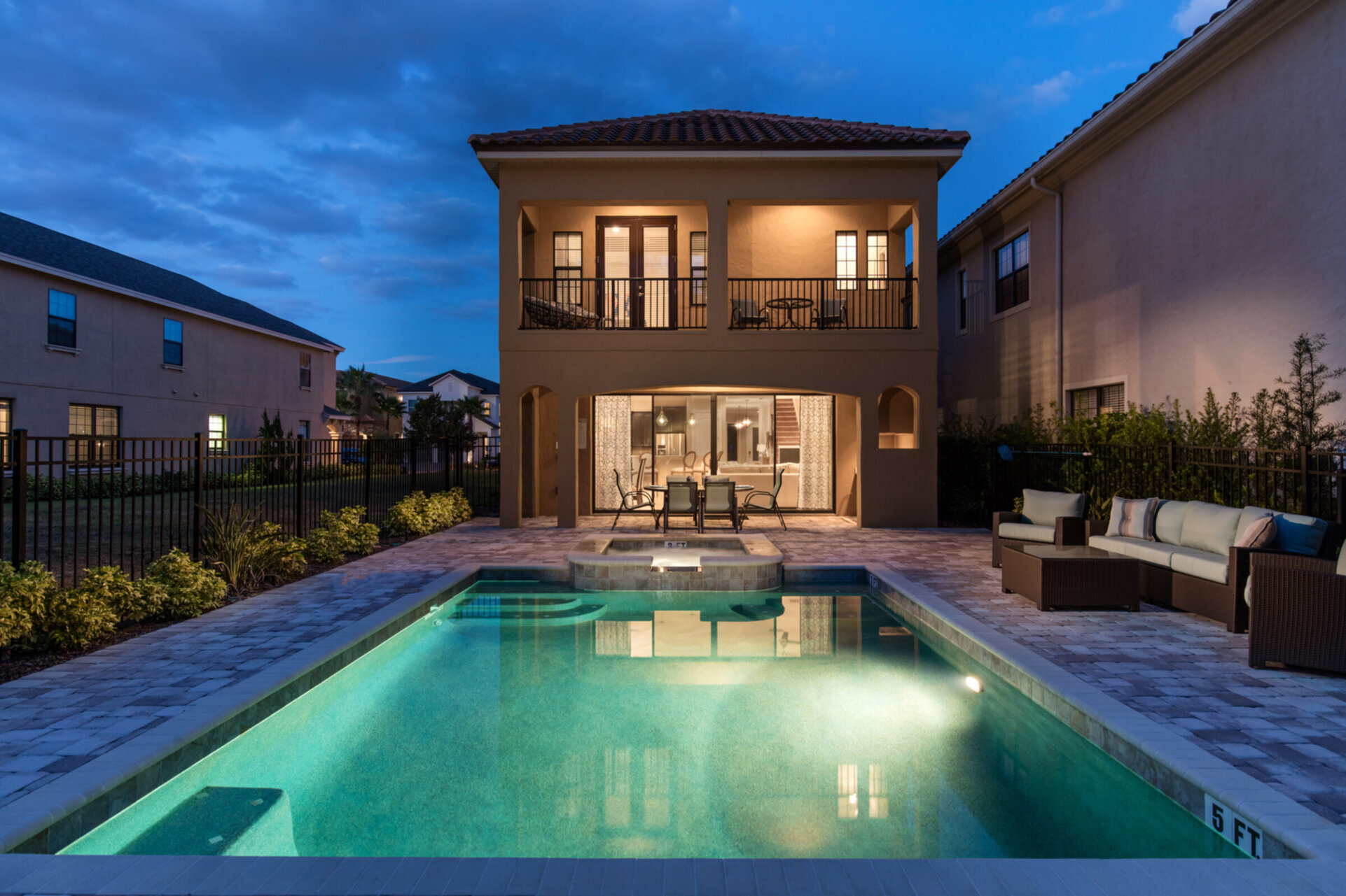 The spacious pool area with sun loungers and relaxation furniture