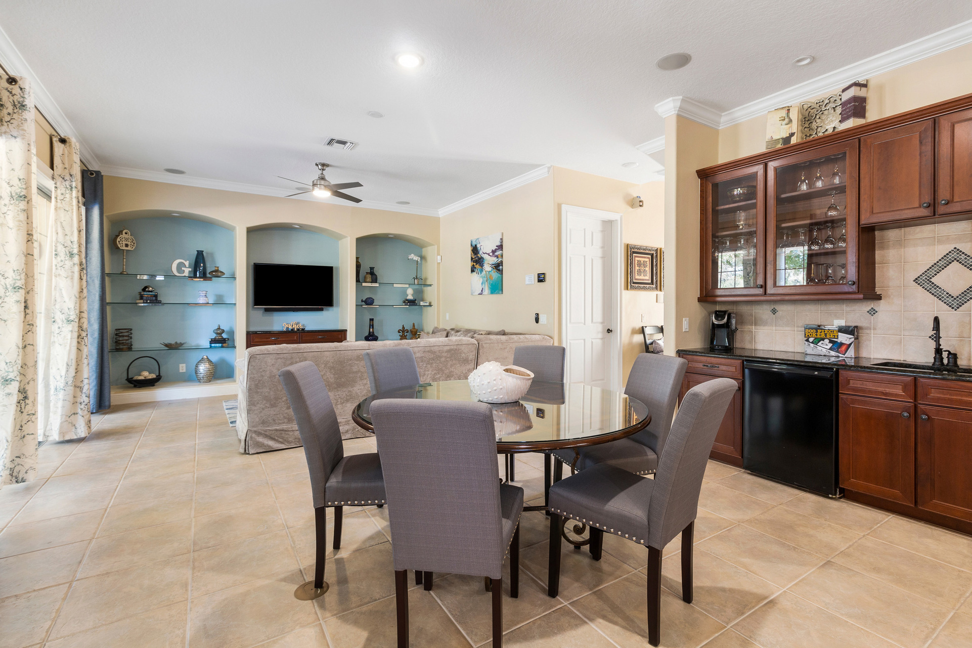 More seating for everyone in the open living space with a table for 6 and a wet bar