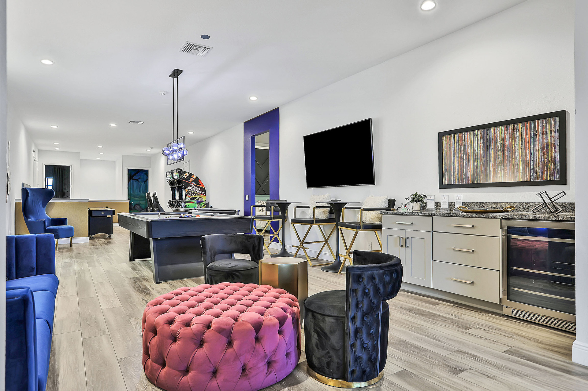 The entertaining loft features a pool table, air hockey, dual Fast and the Furious racers, shuffleboard, and a wall-mounted TV
