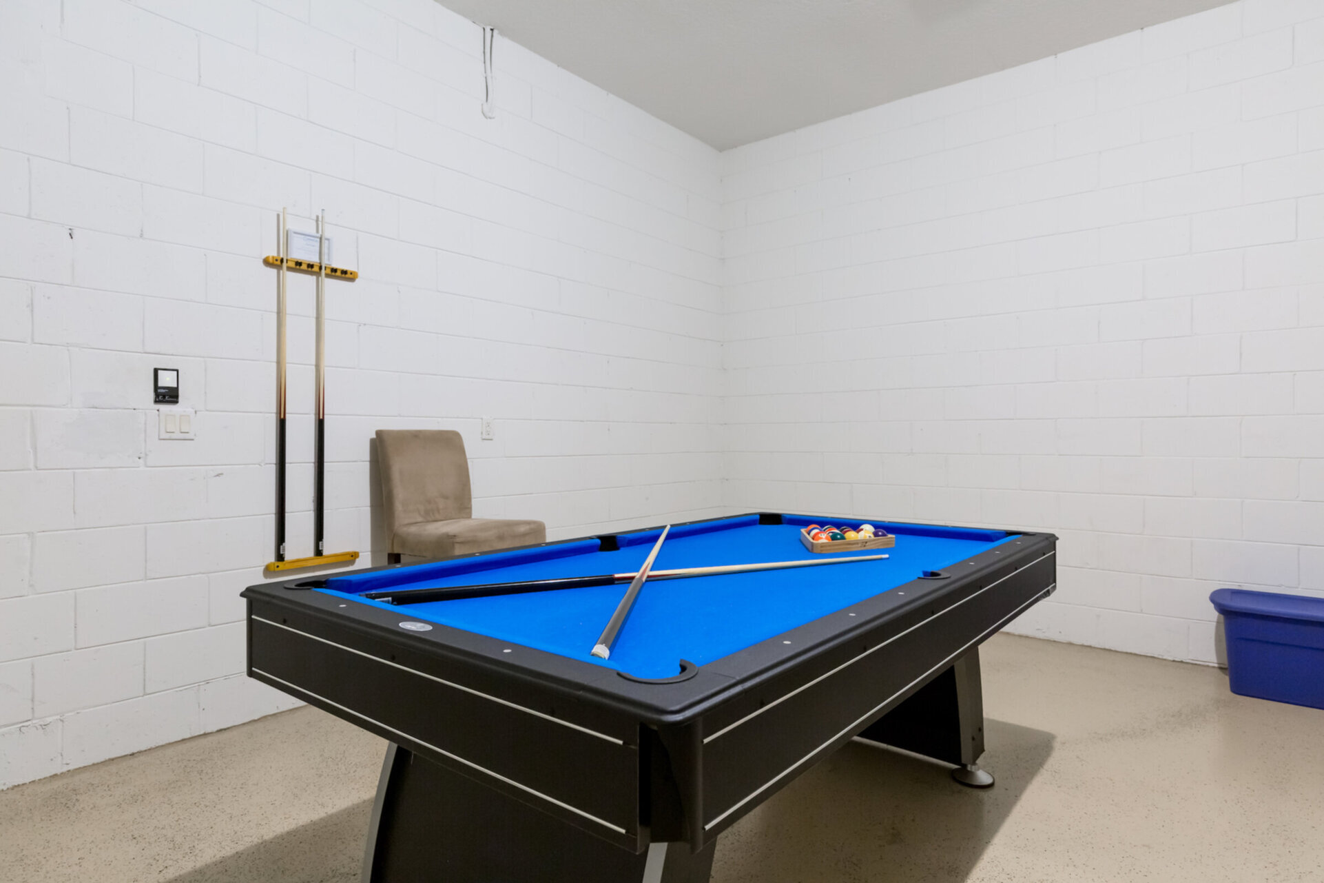 The garage has been converted into a game room with a pool table and comfortable seating