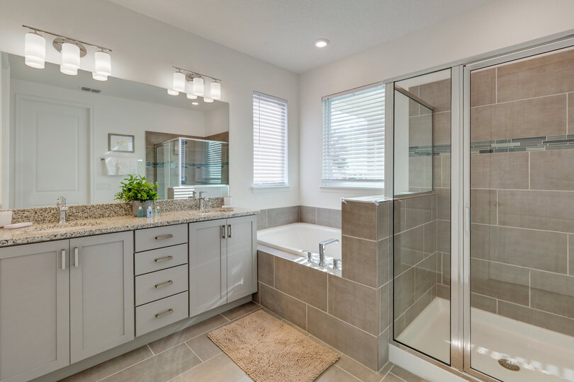 Beautiful ensuite bath has a dual vanity, walk-in shower and garden tub