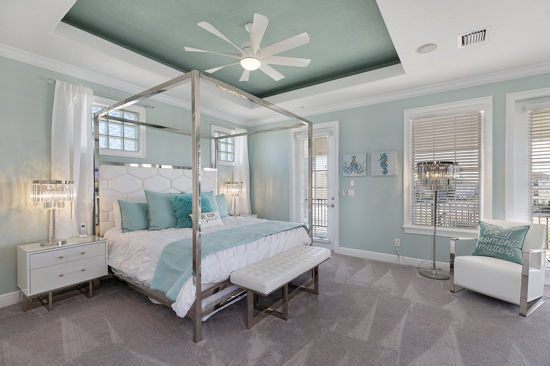The master suite with a luxury king bed and private access to the third-floor balcony