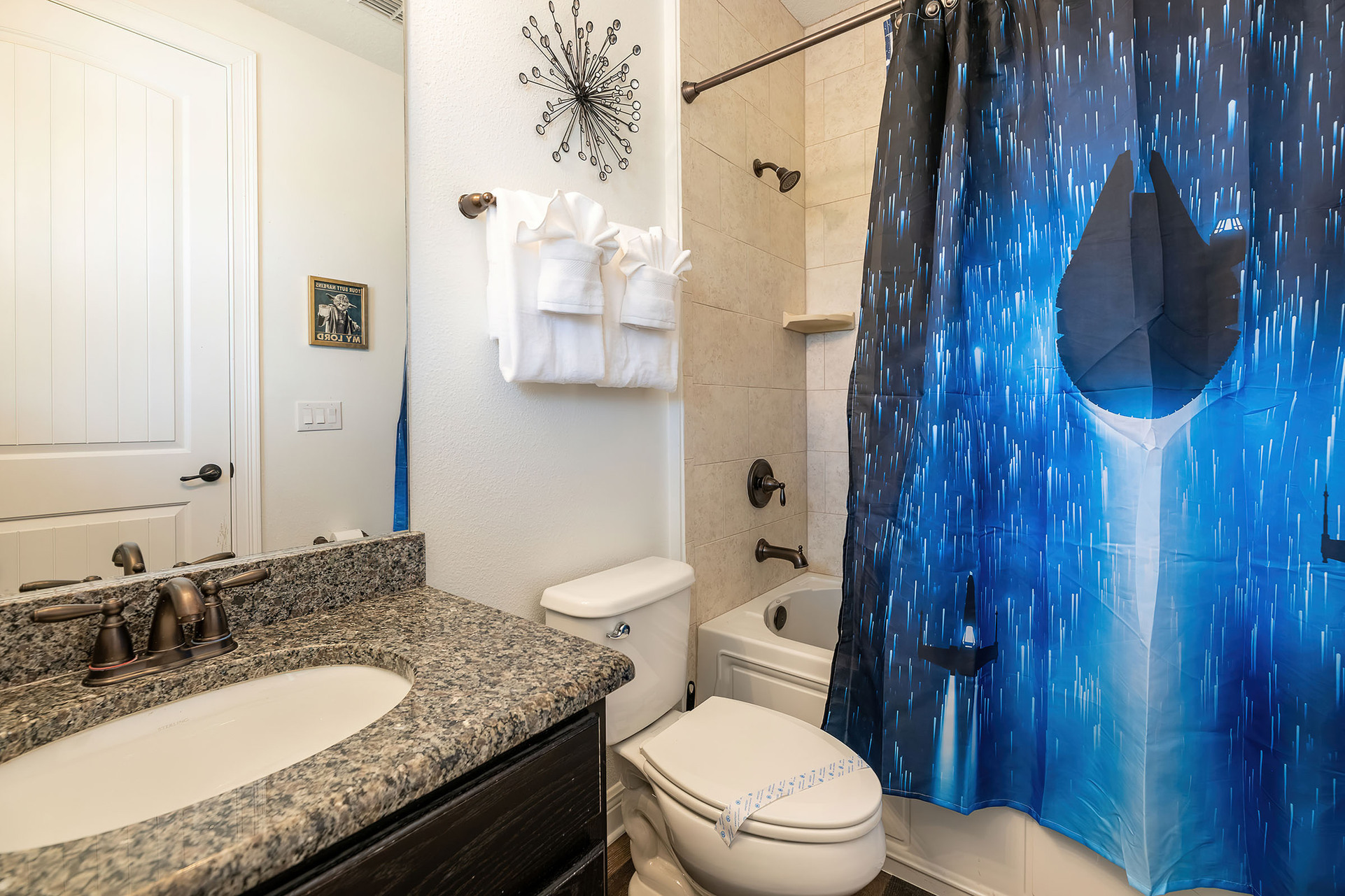 The en suite bathroom offers a combined tub and shower