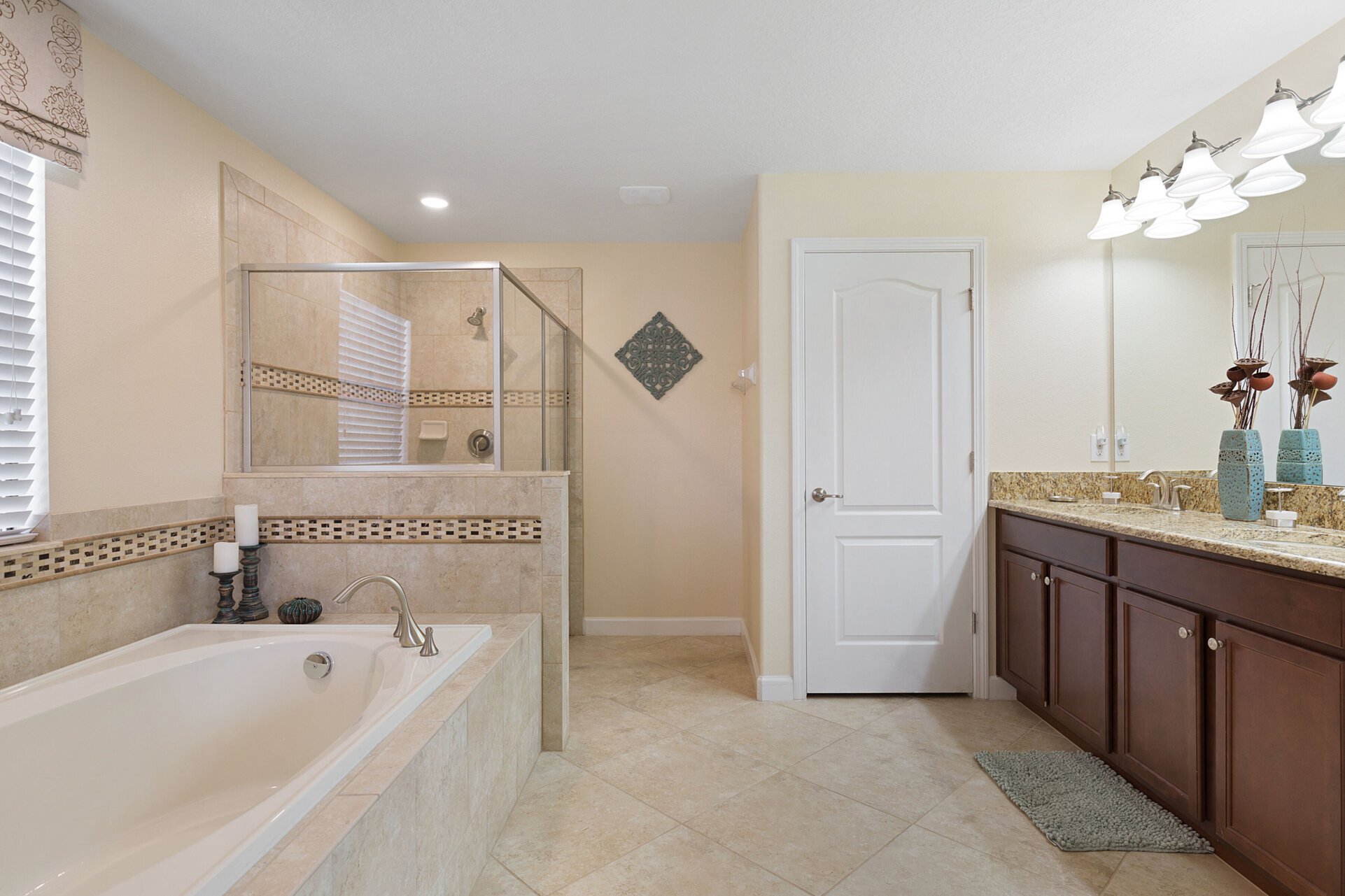 This master suite has an ensuite bathroom that features a dual vanity, walk in shower and garden tub
