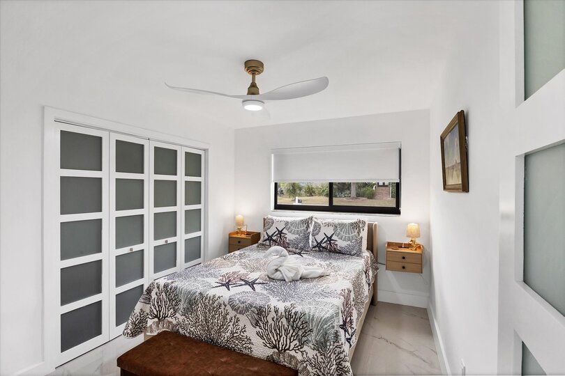 Queen bedroom with one queen bed and 24-inch Smart TV