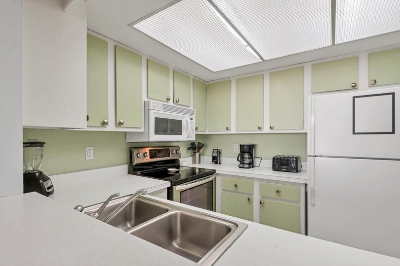 Fully-equipped kitchen overlooking living room/dining room