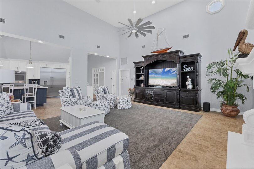 Large, open living space with ample seating, fireplace and 70-inch Smart TV