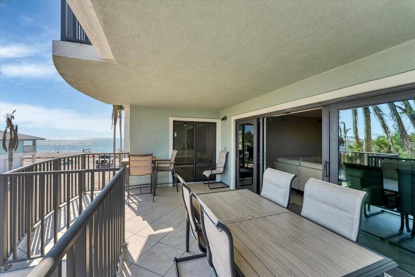 Large balcony overlooking the beach & Gulf of Mexico. Balcony also features two dining tables seating 8 total.