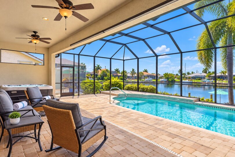 Gorgeous outdoor living space overlooking the sparkling private pool and canal beyond. Great for entertaining.