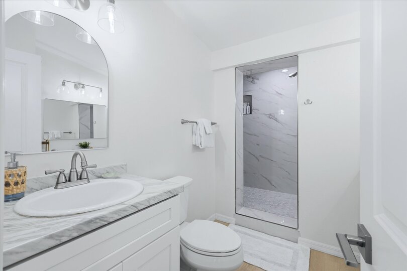 Primary bedroom's attached bathroom with large walk-in shower