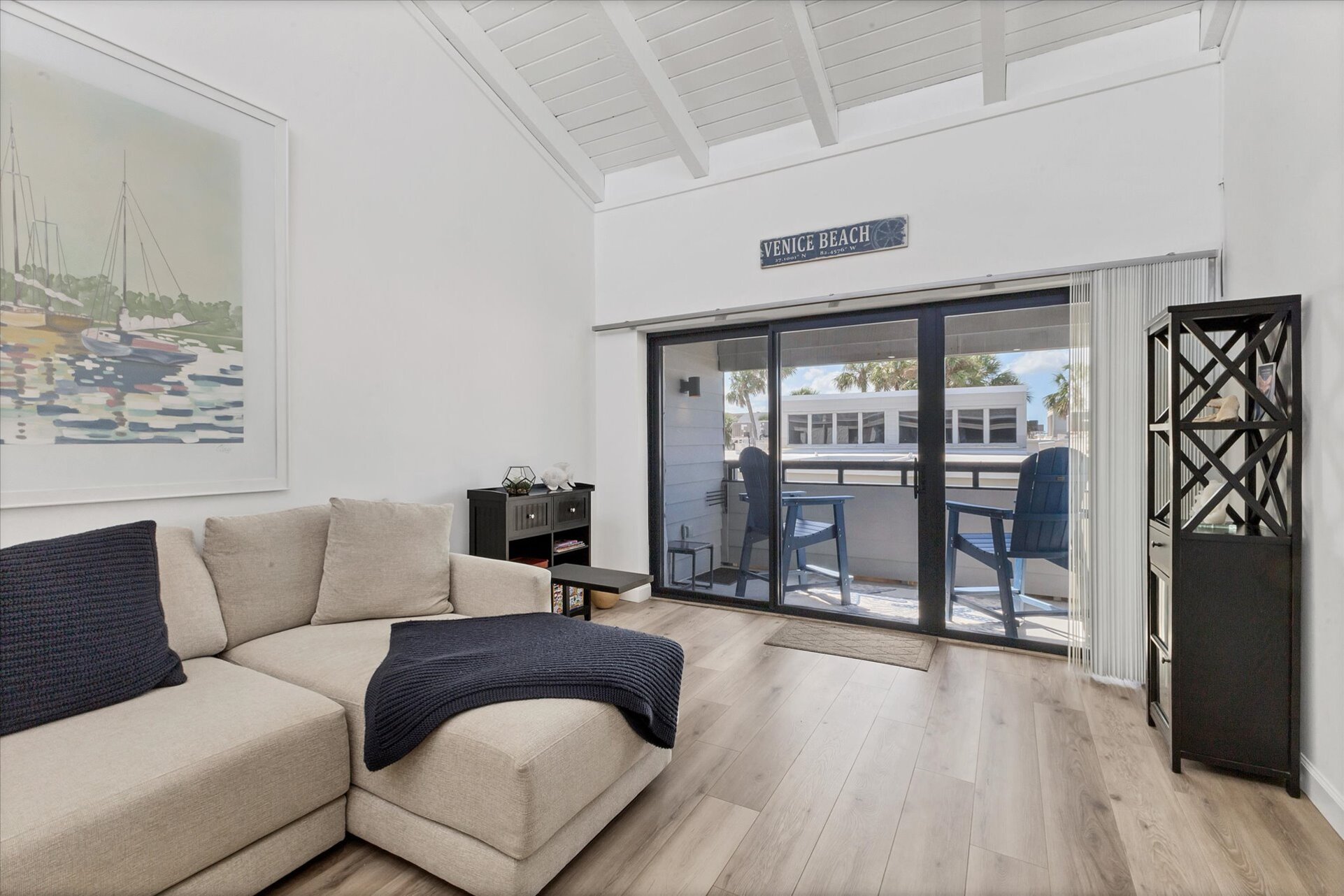 Bright, open living/dining space. Living room features comfy seating, a 65-inch Smart TV and balcony access