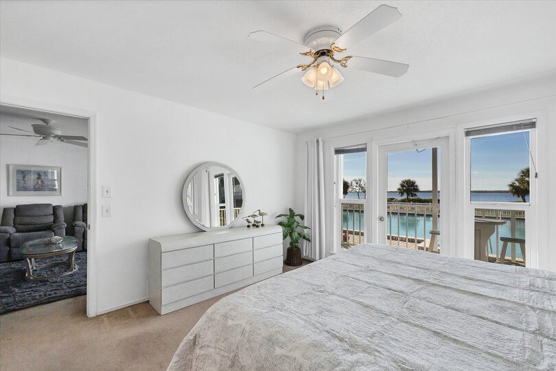Primary bedroom with king bed, attached bathroom, balcony access and amazing water view
