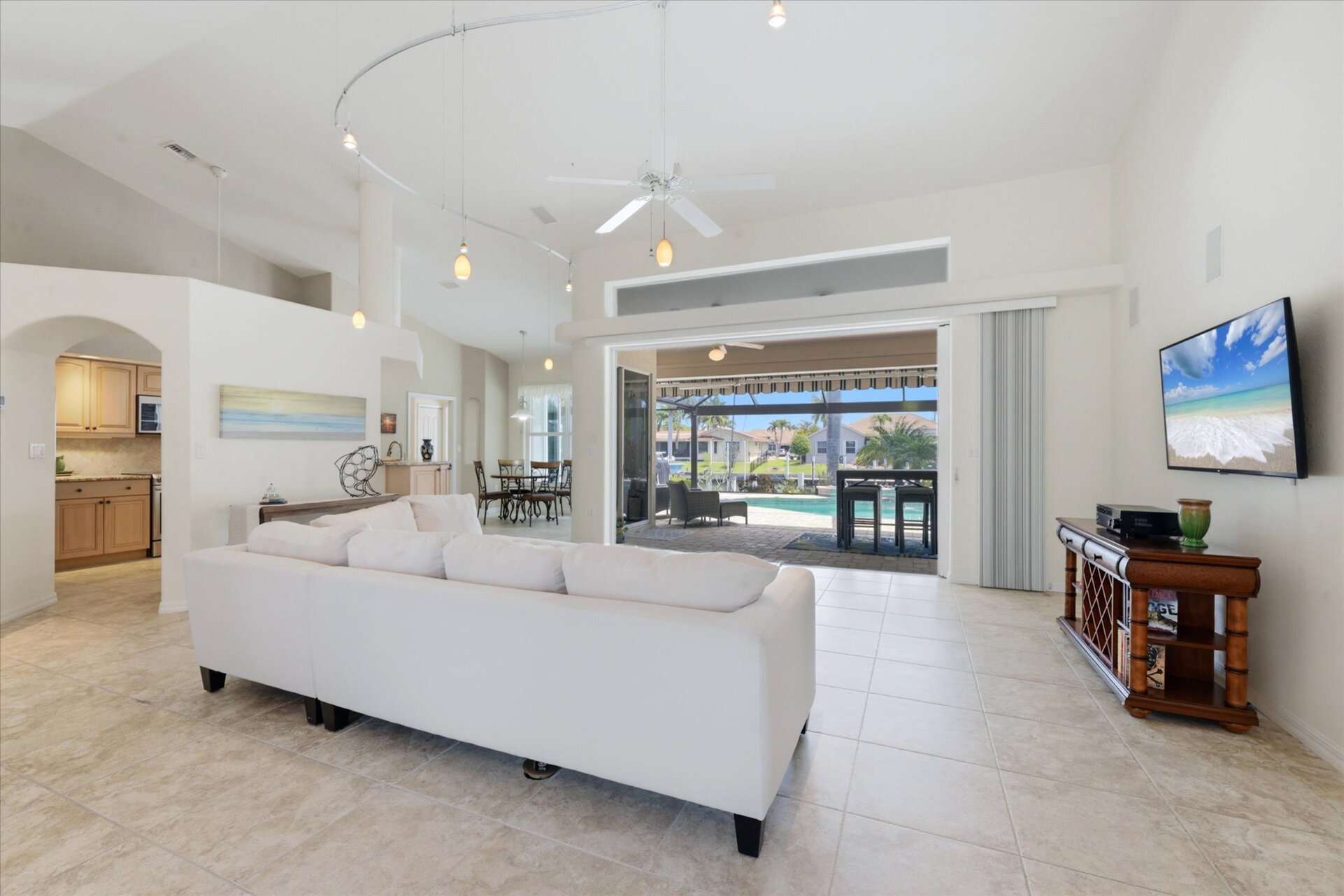 Large living room overlooking the lanai and sparkling pool